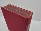 a close up of a red book on a white surface