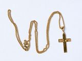 collier avec une croix et une chaîne en or sur fond blanc