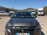 the front view of a grey car parked in a parking lot