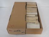 a box full of old records sitting on a white surface