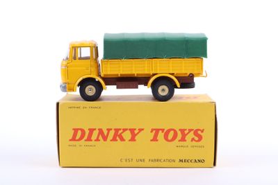 yellow and green dinky toy truck sitting on top of a box