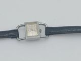 a watch that is sitting on a white surface