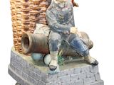 a figurine of a man sitting on top of a basket