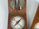 two clocks that are sitting next to each other on a table