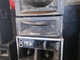a stack of speakers sitting next to each other in a room