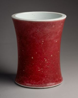 a red and white cup sitting on a table