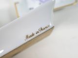 a white plate with a gold inscription on it