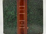 a brown book with a green cover sitting on a table
