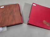 two red folders sitting on a table next to each other