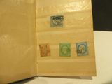 an open book with stamps on it sitting on a table