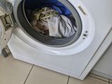a washer and dryer in a bathroom with tiled floor