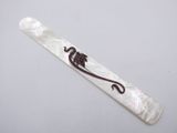 a close up of a white tie with a lizard on it