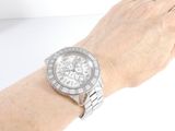 wrist shot of a woman ' s wrist with a diamond watch on it