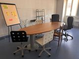 tables and chairs in a room with a board on the wall
