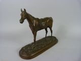 bronze statue of a horse on a wooden base on a white background