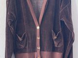 an image of a brown cardigan sweater hanging on a hanger