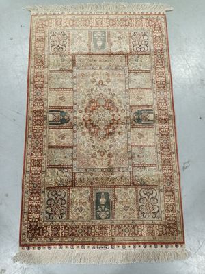 a beige and red rug on a white floor