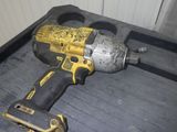 a drill that is sitting on the floor next to a tool box