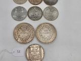 a group of coins sitting on top of a table next to a price tag