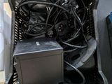 a basket full of wires and a computer on a table