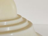 a white lamp that is on a table with a white background
