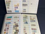 an open book with stamps on it sitting on a table