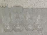 four empty wine glasses sitting on a table