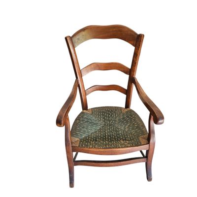 an image of a wooden chair with a woven seat on a white background