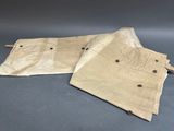 two pieces of tan canvas are sitting on a gray surface