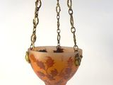 an image of a hanging planter with a leaf design on it