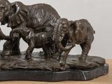 a statue of a family of elephants with a baby elephant