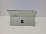 a close up of a white surface with a laptop on it