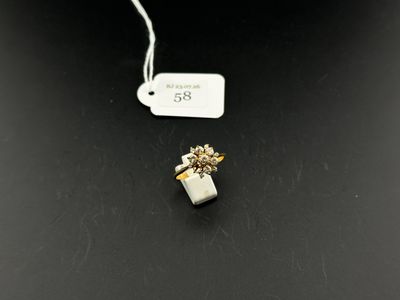 a close up of a tea bag with a small flower on it