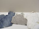 three pairs of shorts and a shirt on a table