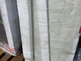 a stack of mattresses sitting on a pallet in a warehouse