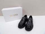 a pair of black shoes sitting on top of a white table