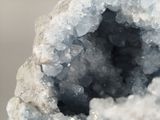 a close up of a piece of rock with a lot of crystals inside of it