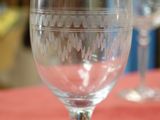 two empty wine glasses sitting on a red table cloth