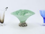 three different colored glass vases sitting next to each other