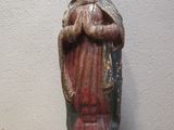 an old statue of a woman holding a baby in her arms