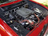 a red car with an engine in the trunk
