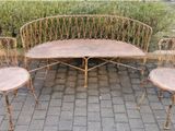 three chairs and a table sitting on a brick patio