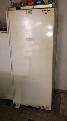 a white refrigerator sitting in a kitchen next to a counter