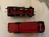 two toy trains sitting next to each other on a table