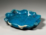 blue and white ceramic bowl with a decorative design on the rim