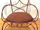 a red chair with a striped seat on a wooden floor