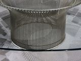 a glass table with a metal base and a glass top