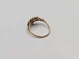 a close up of a gold ring on a white surface