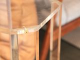 a clear table with a glass top on a wooden floor
