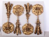 a display of gold colored metal objects on a white surface